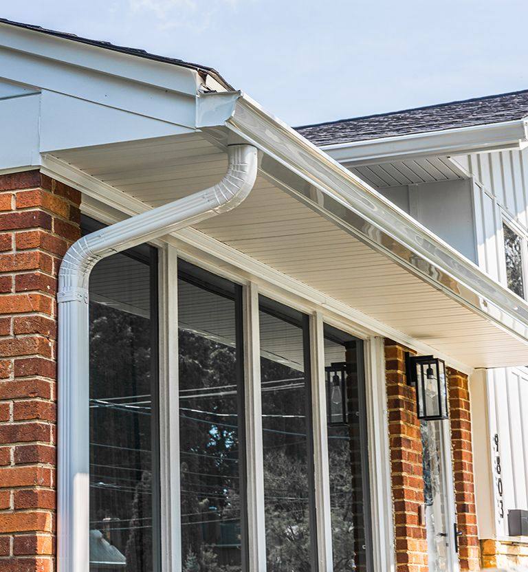 White seamless gutters and downspouts.