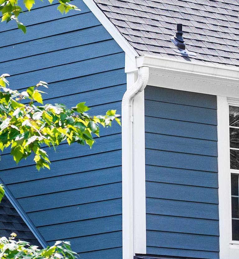 White seamless gutters and downspouts.