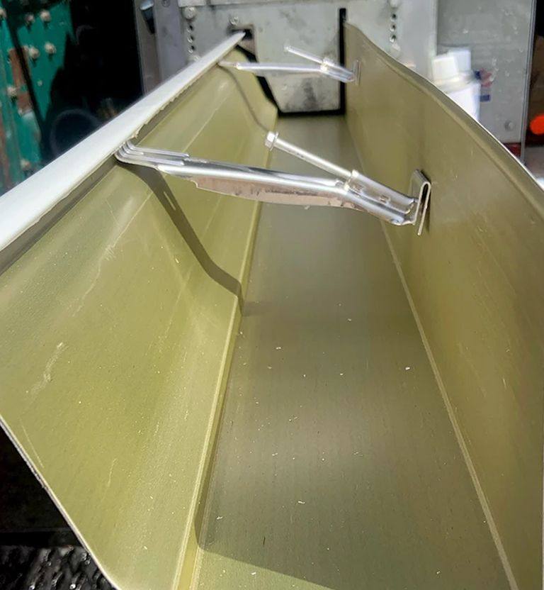 A seamless gutter being run from a truck.
