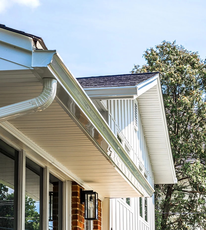 White seamless gutters with hidden vent soffits. 