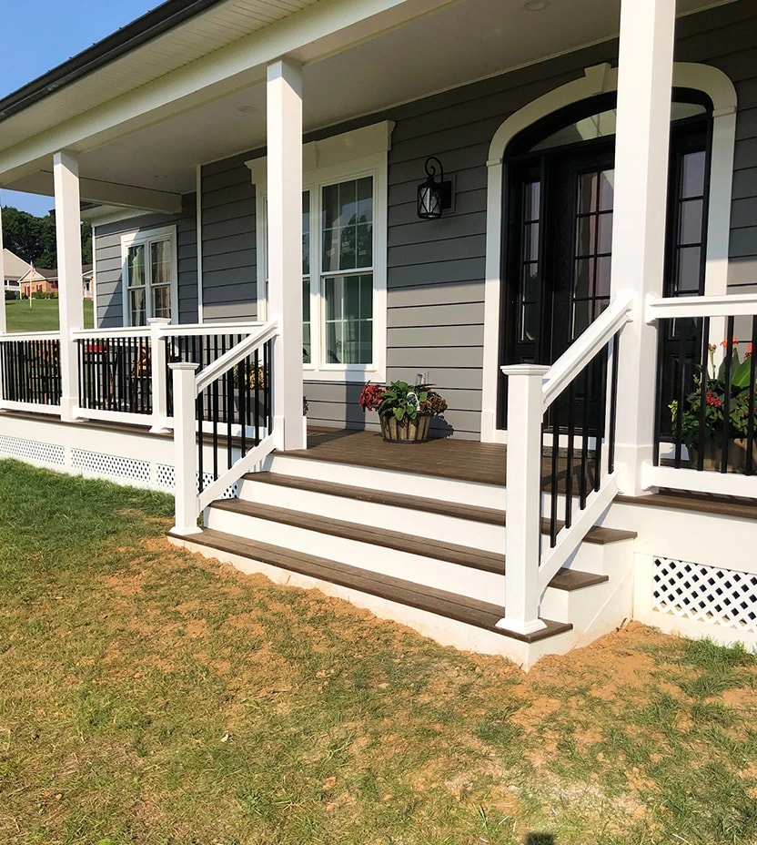 Clean front porch with white posts and composite decking. 