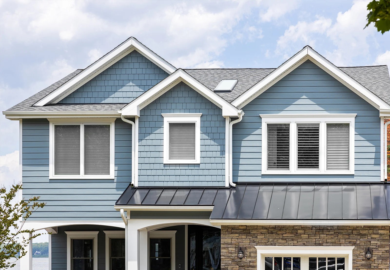 James Hardie booth bay blue siding with standing seam metal roofing.