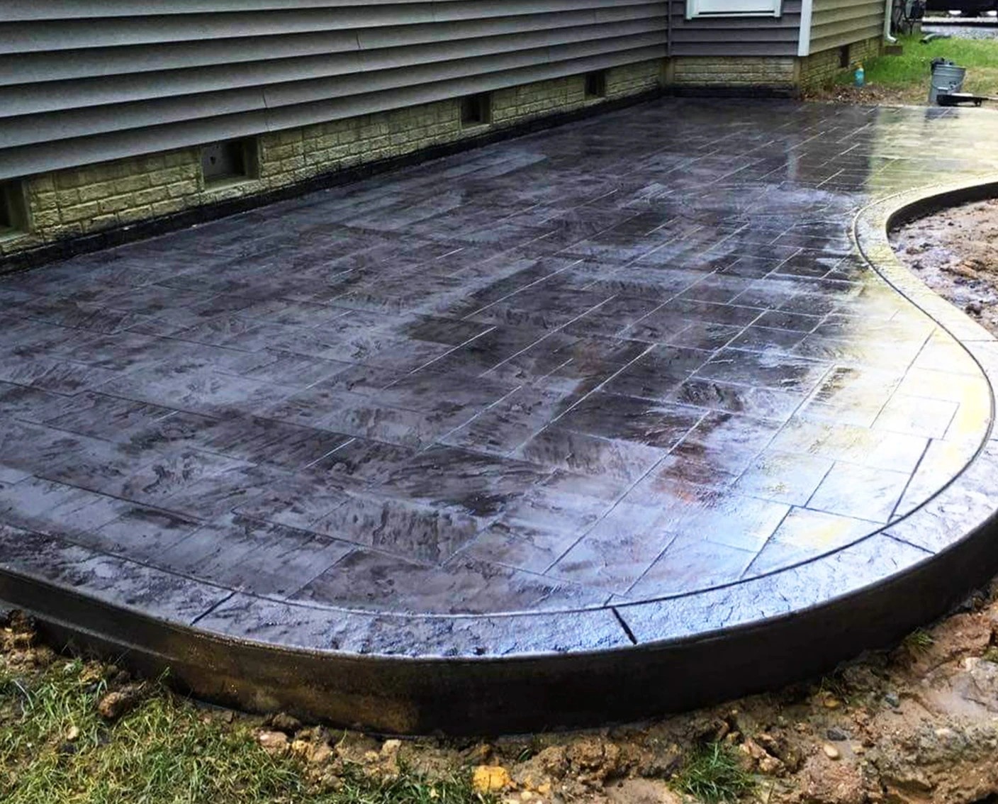 A stamped concrete patio with outdoor living space. 