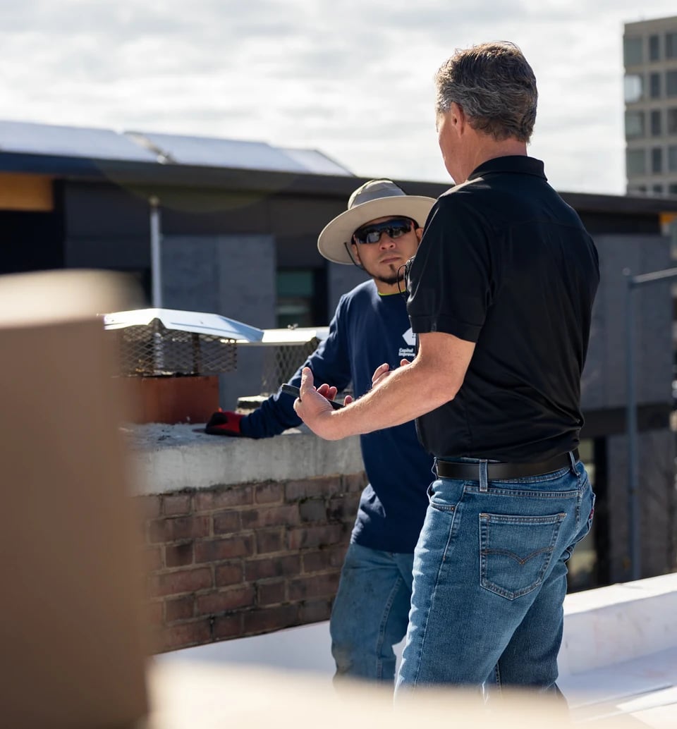 Roofer being trained by Mule-Hide flat roof technician 