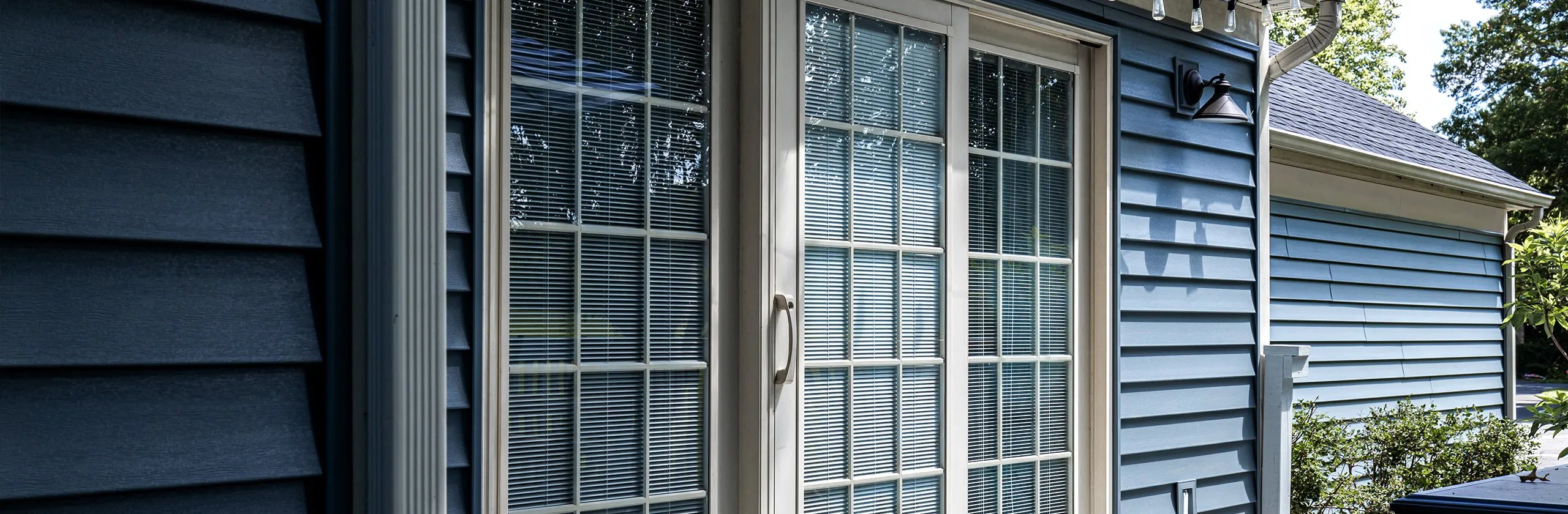 Siding with a new patio sliding glass door. 