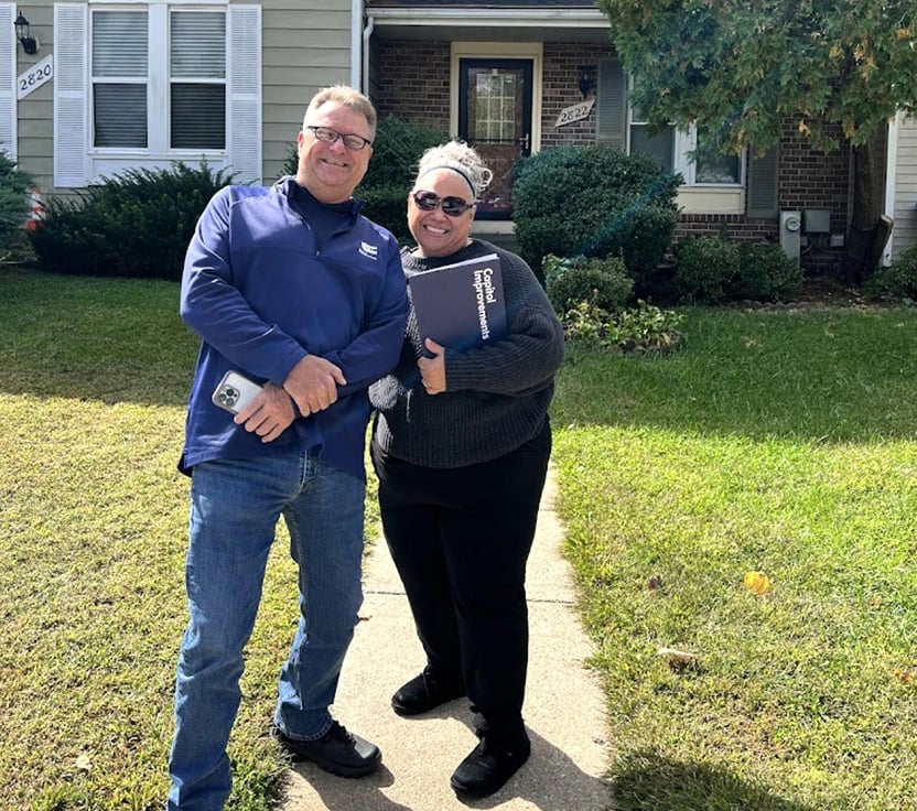 Capitol Improvements team member taking a photo together with a happy client 