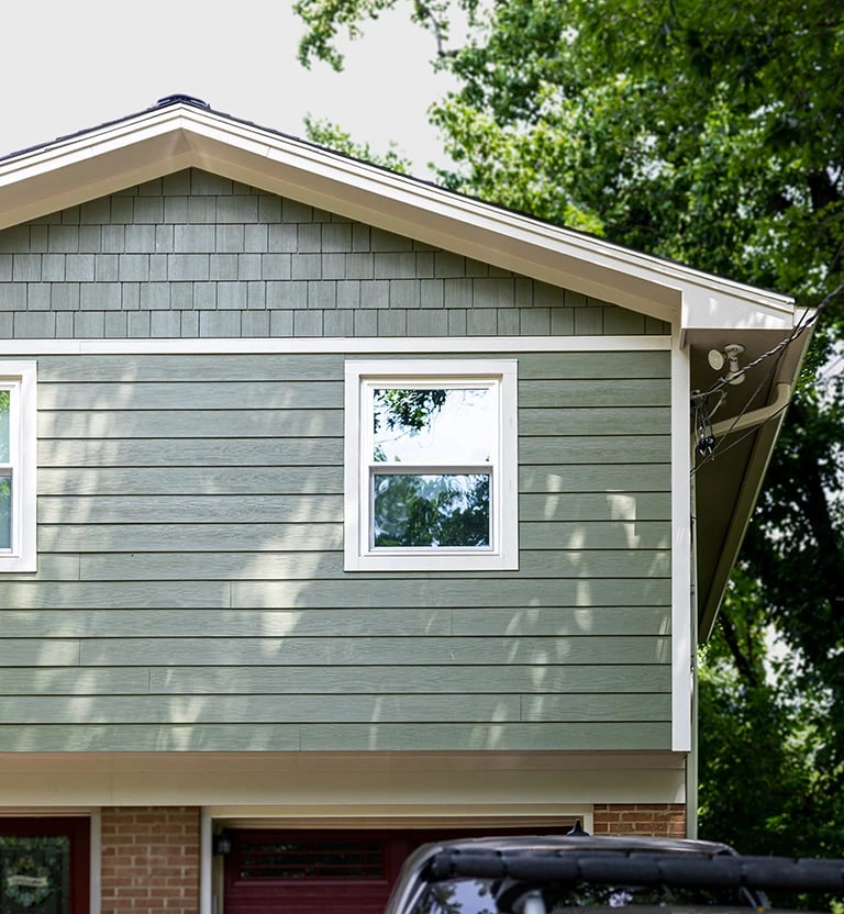 James Hardie rough shake with white trim. 