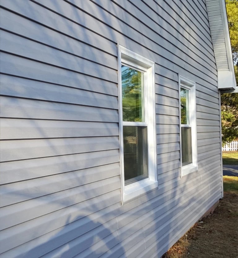 Victorian Grey Dutch Lap vinyl siding with new white windows.