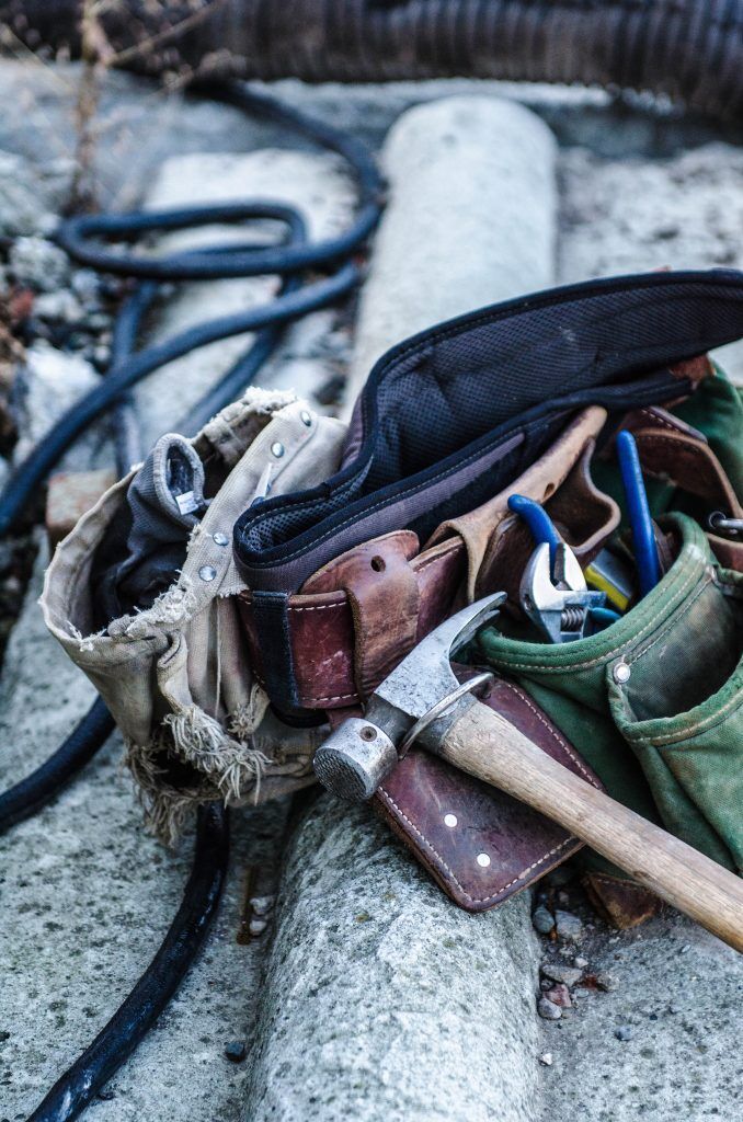 A Washington, D.C. contractor's work boots and tools sitting on a flat roof