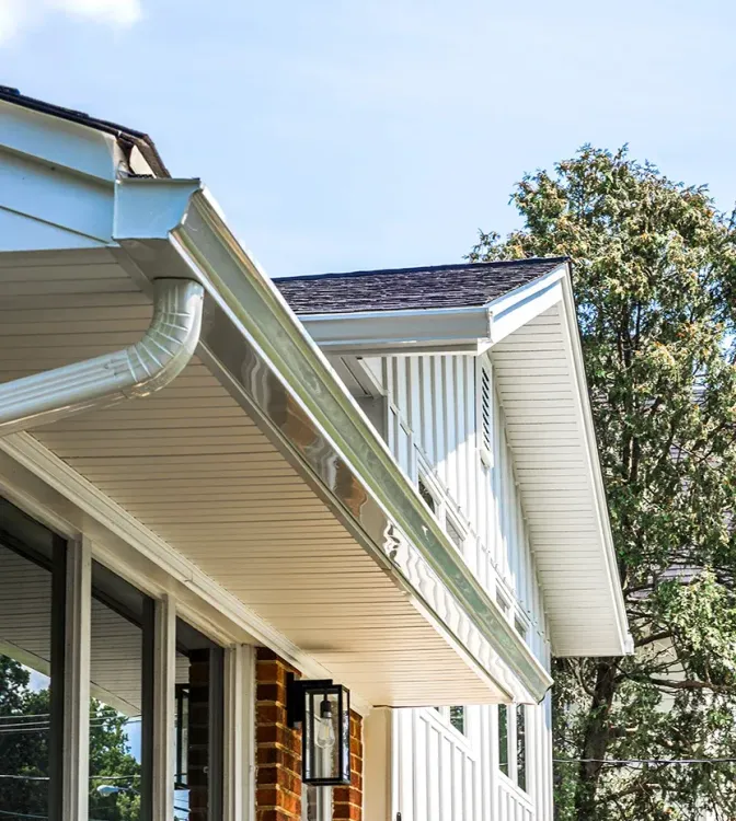 White seamless gutters with hidden vent soffits.