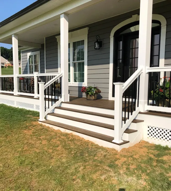 Clean front porch with white posts and composite decking.